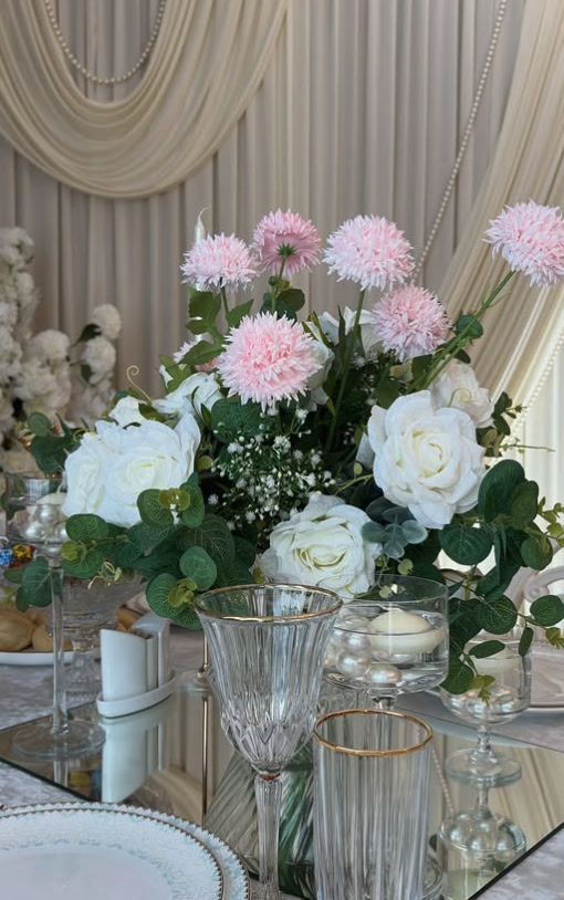 Pink dahlia and white rose centrepiece on a mirror runner