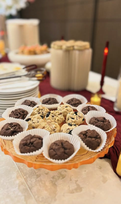 Platter of chocolate and oat cookies beside candles
