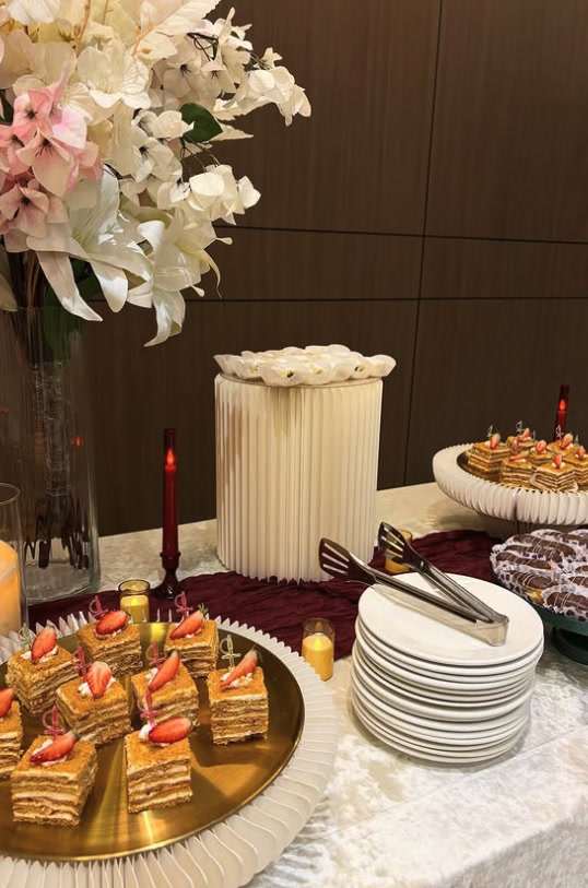 Dessert station with strawberry mille-feuille squares on a gold tray